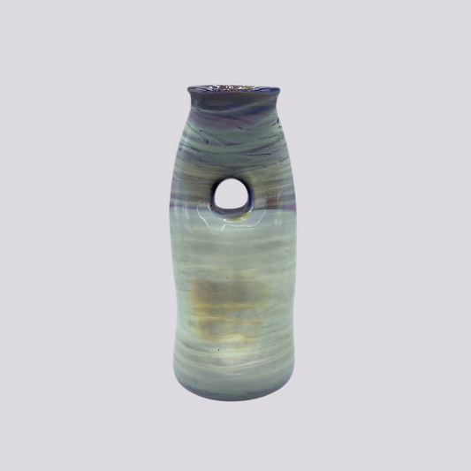 An organically shaped vessel with purple, yellow, green, and blue hues striated.