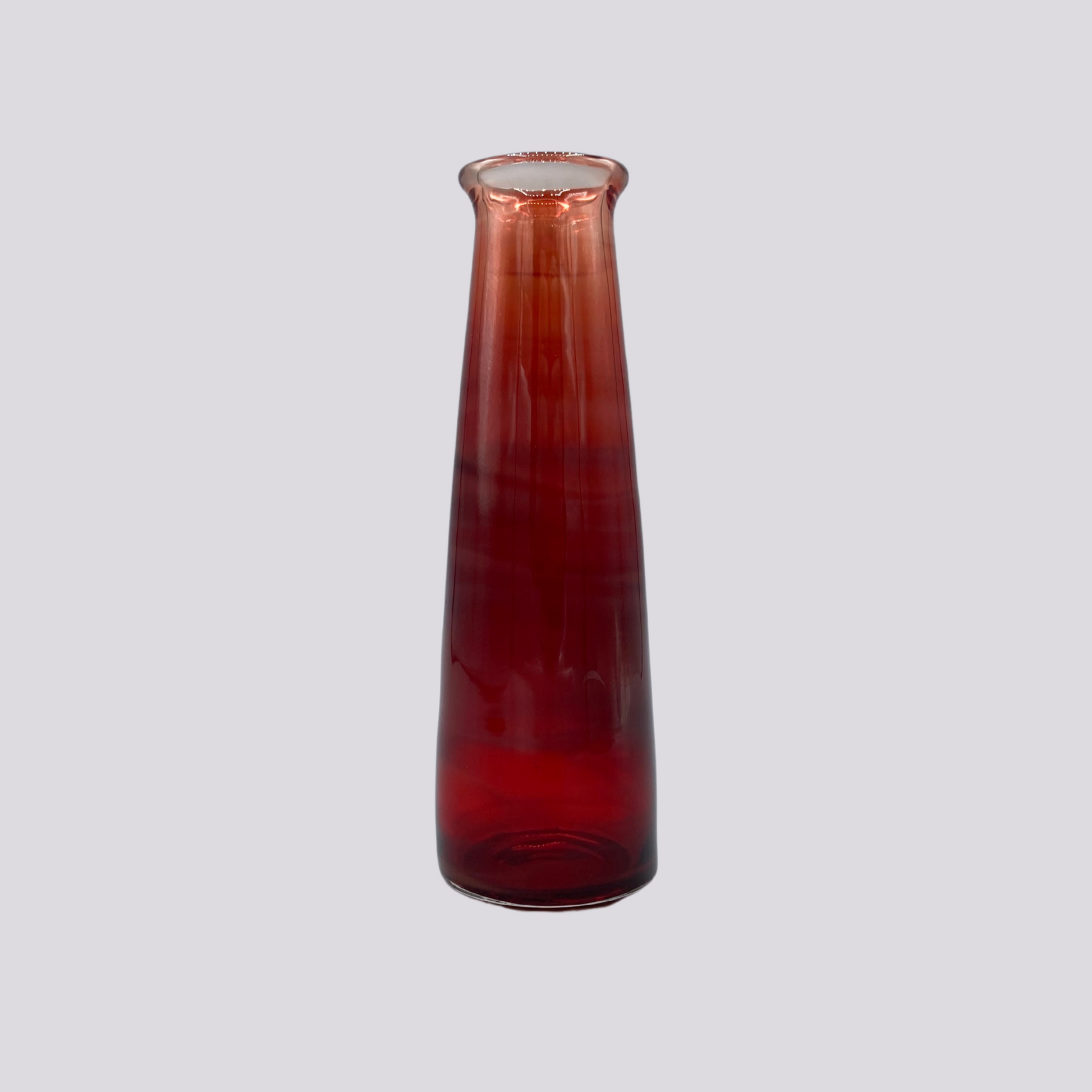 A crimson red vessel against a green background. 